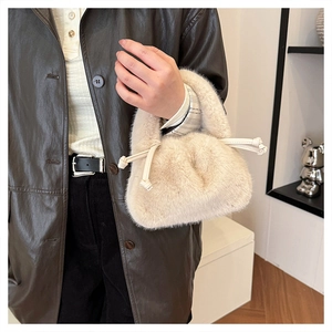 Detail shot of apricot plush bucket bag showing soft faux fur texture and drawstring