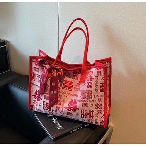 Detail of red bridal tote bag with double happiness character and silk scarf decor
