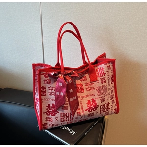 Detailed view of red wedding tote bag with Double Happiness patterns and silk scarf