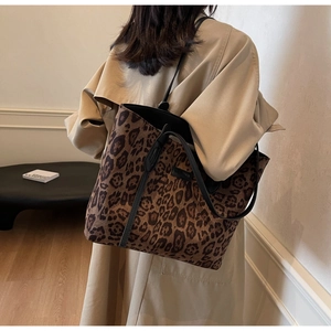 Detail of leopard print tote bag showing fuzzy texture and long black shoulder straps