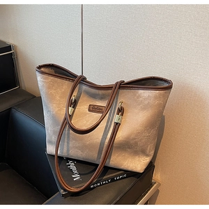 Detail of minimalist tote bag with Fashion leather label on grey matte texture