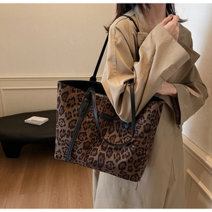 Chic leopard print tote bag styled with a neutral coat for a trendy autumn look