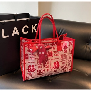 Detail of canvas tote bag with red Double Happiness print and decorative silk scarf handle