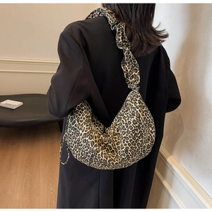 Sac bandoulière léopard style dumpling avec bandoulière à volants porté par un modèle