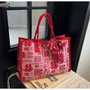 Close-up of red canvas bridal tote bag with Double Happiness print and silk ribbon
