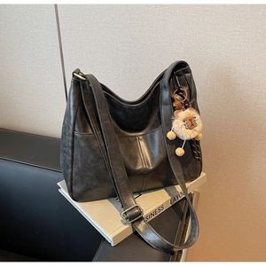 Detail of vintage large tote bag with textured faux leather and adjustable shoulder strap