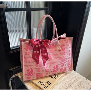 Detail of pink canvas wedding tote with Double Happiness pattern and red satin bow ribbon