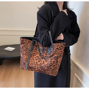 Chic leopard print tote bag styled with a minimalist black blazer for a trendy urban look