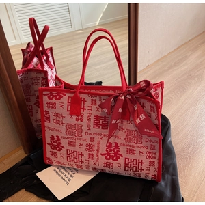 Detail of red wedding tote bag with Double Happiness print and silk ribbon bow