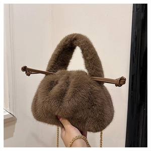 Detail of plush faux fur bucket bag in mocha brown with gold chain and drawstring