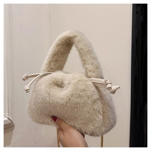 Detail view of plush oatmeal bucket bag with soft faux fur texture and gold chain strap