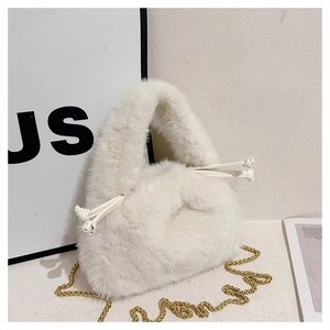 Close-up of white faux fur bucket bag with drawstring closure and gold metal chain strap