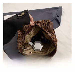 Detailed interior view of leopard print tote bag showing large capacity and striped lining