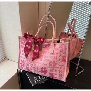 Detail of pink canvas wedding tote bag featuring Chinese Double Happiness and silk bow charm