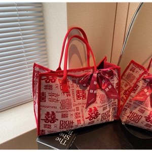 Detail of red wedding tote bag with Double Happiness print and decorative silk scarf