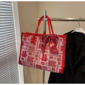 Detailed close-up of a red wedding tote bag with silk scarf and Double Happiness print