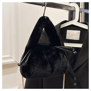 Detail of plush faux fur bucket bag with golden chain strap and leather drawstring