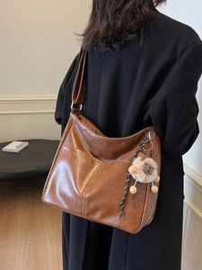 Brown vintage large capacity tote bag with adjustable strap and lion plush pendant