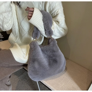 Détail du sac à main en fausse fourrure pelucheuse avec poignée anneau doré élégante