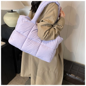 Detailed view of lavender puffer tote bag featuring quilted nylon and spacious interior