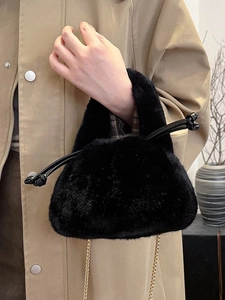Fluffy black plush bucket bag with gold chain strap and decorative leather knot