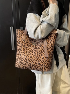 Leopard print tote bag with brown leather straps and gold metal lettering decoration