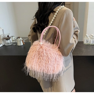 Pink faux fur handbag featuring elegant pearl handle and soft plush texture detail