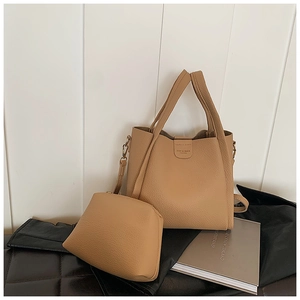 Detail of light tan lychee texture tote bag set with inner pouch and gold logo
