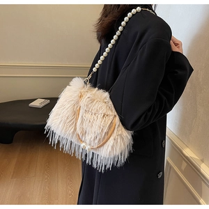 Detail of faux fur bucket bag with pearl strap and brown handle for winter fashion