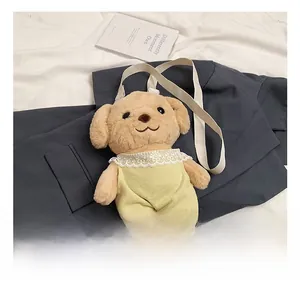 Detail of plush poodle crossbody bag with yellow overalls and white lace collar detail