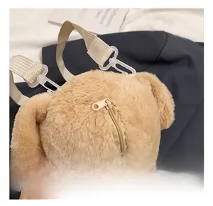Detail view of plush poodle dog bag showing metal zipper and white plastic swivel hook