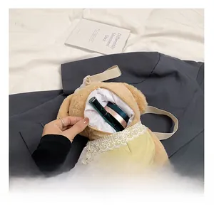 Detail of plush poodle crossbody bag interior holding a lipstick and powder compact