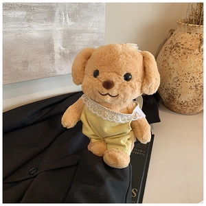 Detail of cute brown plush poodle bag wearing a yellow striped suit with lace trim