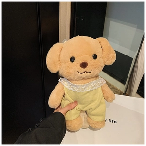 Close-up of cute plush poodle bag with yellow romper and white lace collar detail