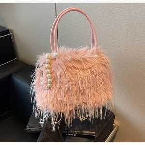 Close-up of pink faux fur handbag featuring elegant pearl strap and leather handle