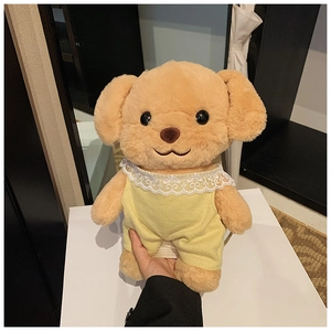 Detail of cute stuffed toy poodle in yellow corduroy dress with white lace collar and strap
