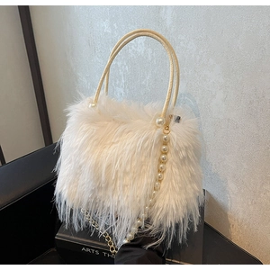 Detailed view of white faux fur handbag featuring elegant pearl handle and chain strap
