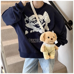 Detail of cute plush poodle crossbody bag paired with navy blue rose printed sweatshirt