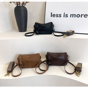 Detailed display of vintage pillow bags in black, camel and dark brown with wide straps