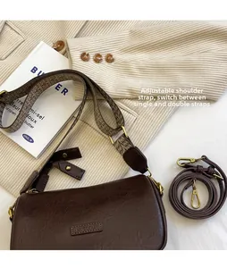 Close-up of vintage brown pillow bag with jacquard strap and retro gold hardware