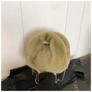 Vue détaillée de la texture en fausse fourrure vert olive et de la bandoulière chaîne