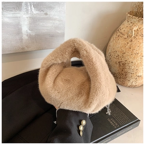 Vue macro détaillée de la texture de fausse fourrure douce et de la chaîne sur le sac beige