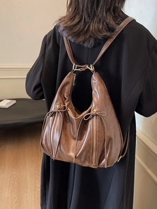 Brown retro leather hobo tote bag with bow detail and adjustable shoulder straps