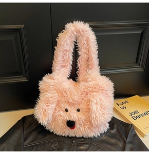 Detail of pink faux fur tote bag featuring a cute cartoon dog face and fluffy texture
