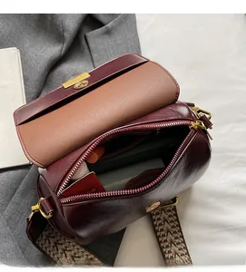 Internal view showing spacious capacity of burgundy retro crossbody pillow bag