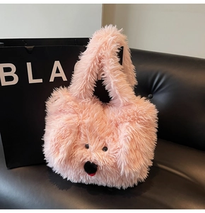 Detail of pink faux fur puppy tote bag with cute facial features on a leather seat