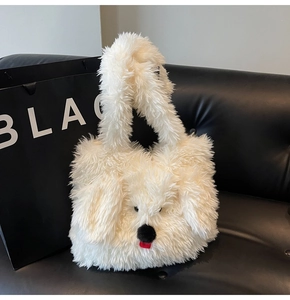 Detail of white plush puppy tote bag with cute red tongue and fuzzy black nose features
