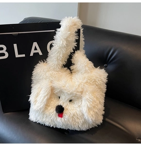 Close-up of white plush tote bag with a cute puppy face design on a black sofa