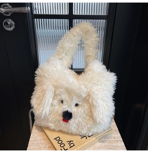 Detailed shot of white plush puppy tote bag with soft texture on marble surface