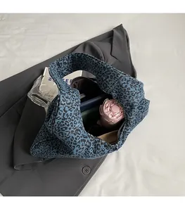 Spacious interior of leopard print canvas bag showing umbrella and wallet storage